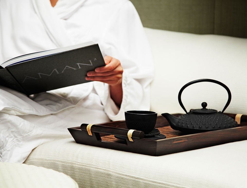 View the relaxed atmosphere with tea and reading a book at Aman Spa by The Connaught.
