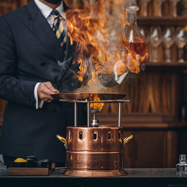 A dish set on fire by a man at The Connaught Grill