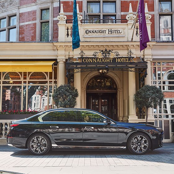 Exterior of The Connaught Hotel with one of the car fleets parked outside on a sunny day